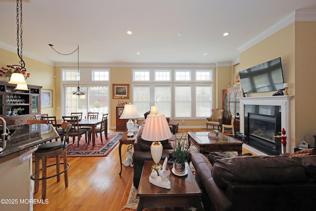 26 Aspen Ln, Tinton Falls, NJ 07724 - living area with plenty of natural light, a glass covered fireplace, crown molding, and light wood finished floors