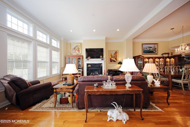 26 Aspen Ln, Tinton Falls, NJ 07724 - living area with wood finished floors, a fireplace, recessed lighting, ornamental molding, and a notable chandelier