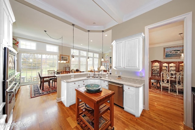 26 Aspen Ln, Tinton Falls, NJ 07724 - kitchen featuring light wood-type flooring, ornamental molding, a sink, stainless steel appliances, and a peninsula