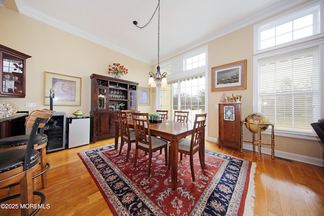 26 Aspen Ln, Tinton Falls, NJ 07724 - dining space featuring a notable chandelier, light wood-style floors, and ornamental molding