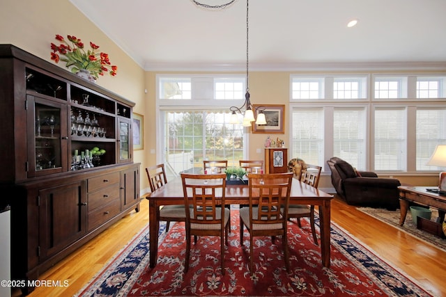 26 Aspen Ln, Tinton Falls, NJ 07724 - dining space featuring a chandelier, light wood-style flooring, and crown molding