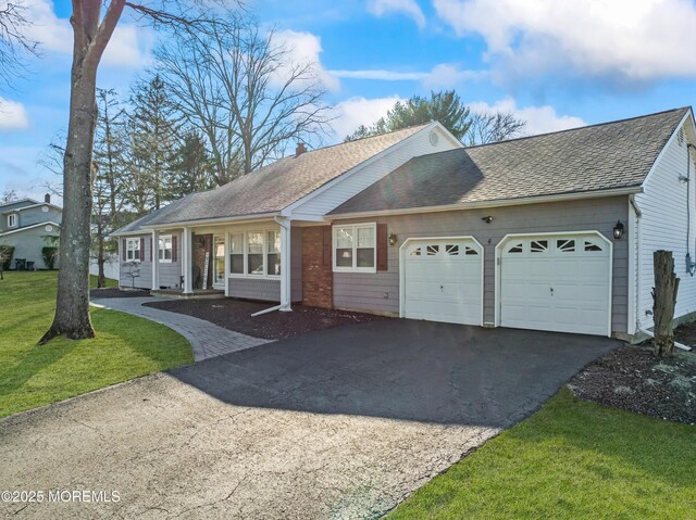 4 Whitman Rd, Morganville, NJ 07751 - ranch-style home with a front yard, driveway, roof with shingles, a chimney, and a garage
