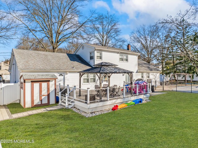 4 Whitman Rd, Morganville, NJ 07751 - back of property featuring a storage unit, a fenced backyard, a gazebo, a yard, and an outdoor structure