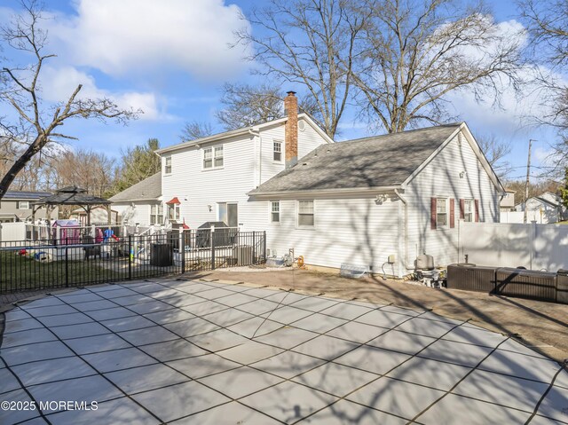 4 Whitman Rd, Morganville, NJ 07751 - back of house featuring a patio area, a residential view, a chimney, and fence