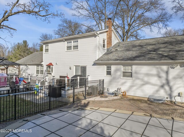 4 Whitman Rd, Morganville, NJ 07751 - rear view of house with a shingled roof, a chimney, a patio, and fence