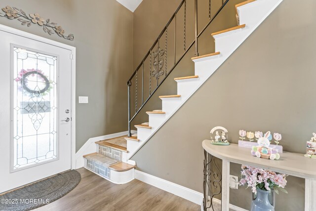 4 Whitman Rd, Morganville, NJ 07751 - entrance foyer with stairway, a healthy amount of sunlight, and wood finished floors