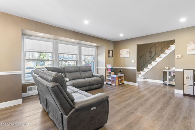 4 Whitman Rd, Morganville, NJ 07751 - living area featuring stairway, wood finished floors, visible vents, and a wealth of natural light