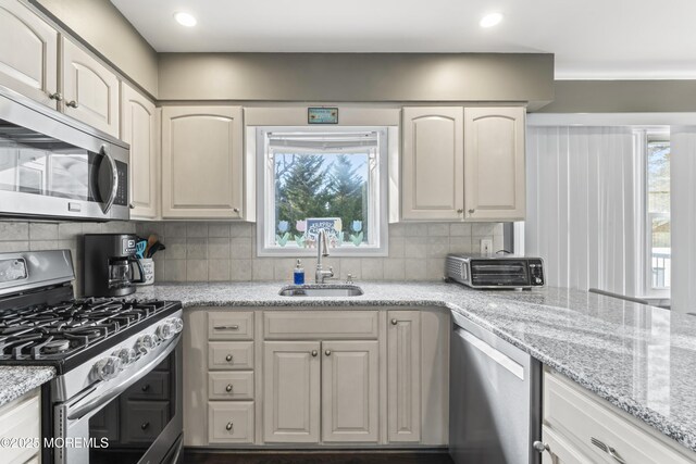 4 Whitman Rd, Morganville, NJ 07751 - kitchen with a sink, backsplash, a wealth of natural light, and stainless steel appliances