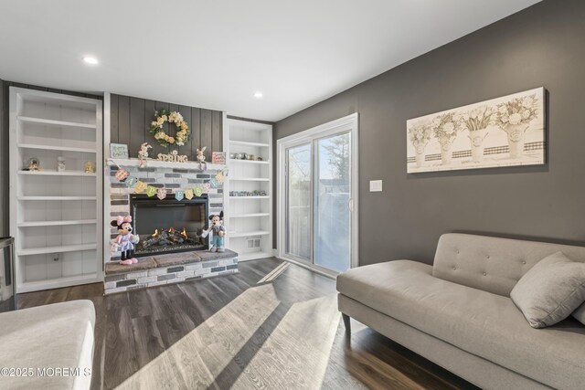 4 Whitman Rd, Morganville, NJ 07751 - living area with built in features, dark wood-type flooring, a brick fireplace, and recessed lighting