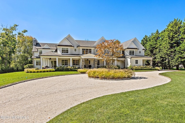20 Conover Ln, Rumson, NJ 07760 - view of front of house featuring a chimney, gravel driveway, and a front yard
