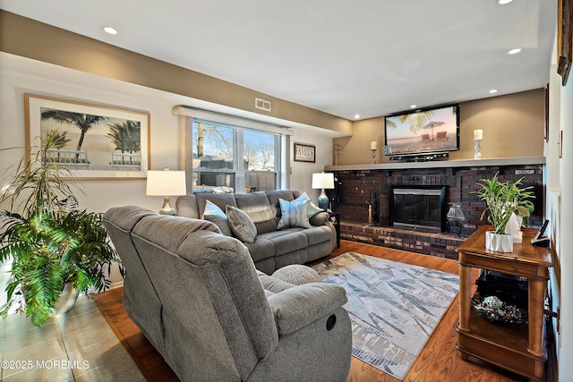 1107 Frontage Rd, Toms River, NJ 08753 - living room with visible vents, recessed lighting, a brick fireplace, and wood finished floors