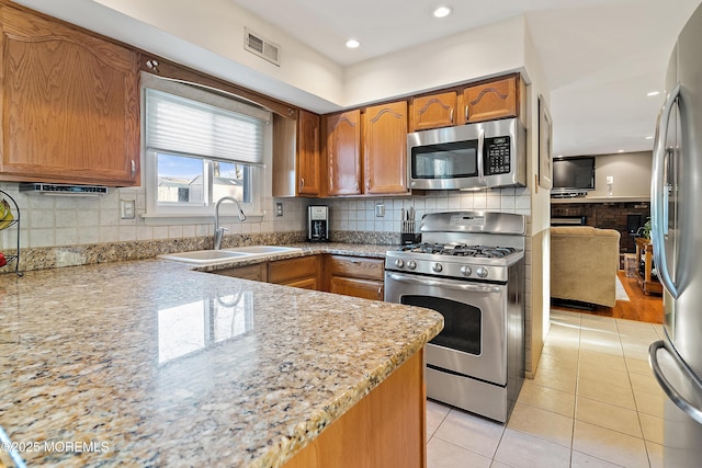 1107 Frontage Rd, Toms River, NJ 08753 - kitchen featuring tasteful backsplash, visible vents, light tile patterned floors, appliances with stainless steel finishes, and a sink