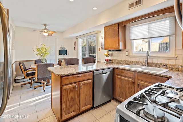 1107 Frontage Rd, Toms River, NJ 08753 - kitchen with visible vents, a peninsula, a sink, appliances with stainless steel finishes, and brown cabinets