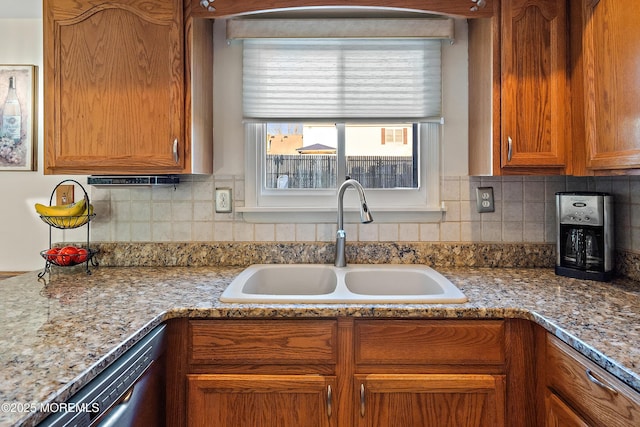 1107 Frontage Rd, Toms River, NJ 08753 - kitchen featuring light stone counters, brown cabinetry, a sink, dishwasher, and backsplash