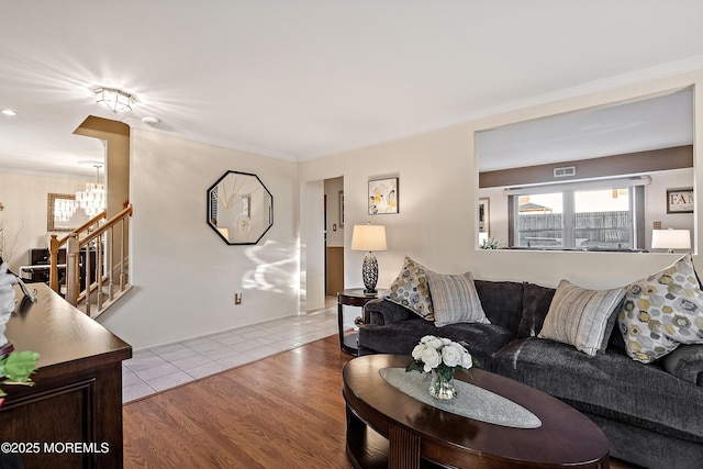 1107 Frontage Rd, Toms River, NJ 08753 - living area with visible vents, crown molding, an inviting chandelier, and wood finished floors