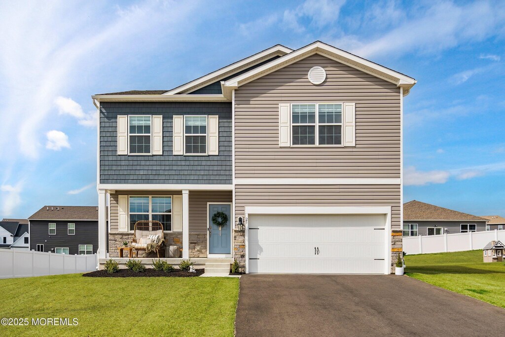 25 Outsail Ave, Barnegat, NJ 08005 - view of front of property featuring stone siding, driveway, a front lawn, and a porch