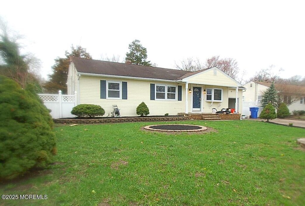 986 Stamler Dr, Toms River, NJ 08753 - single story home with a chimney, fence, and a front yard