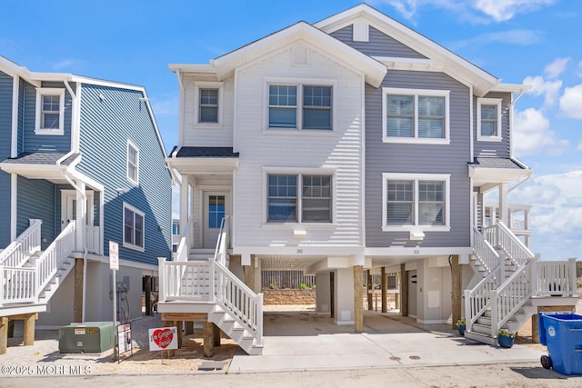 30 Elder St, Mantoloking, NJ 08738 - view of front facade with stairs, a carport, and driveway