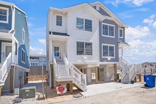 30 Elder St, Mantoloking, NJ 08738 - view of front of property featuring stairway, a carport, and driveway