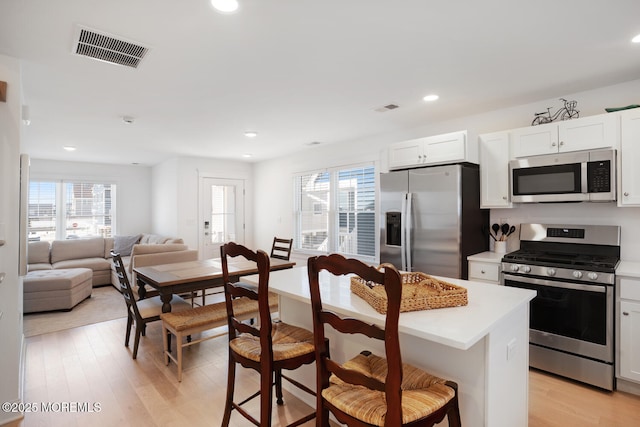 30 Elder St, Mantoloking, NJ 08738 - kitchen featuring stainless steel appliances, a breakfast bar area, a center island, light countertops, and recessed lighting
