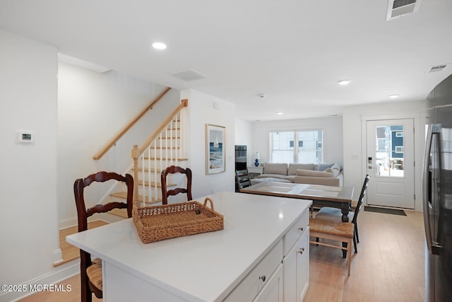 30 Elder St, Mantoloking, NJ 08738 - kitchen featuring light wood-style flooring, white cabinets, a kitchen island, recessed lighting, and light countertops