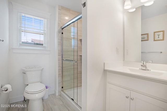 30 Elder St, Mantoloking, NJ 08738 - bathroom featuring toilet, vanity, a stall shower, and baseboards