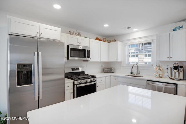 30 Elder St, Mantoloking, NJ 08738 - kitchen with stainless steel appliances, a sink, white cabinetry, light countertops, and recessed lighting