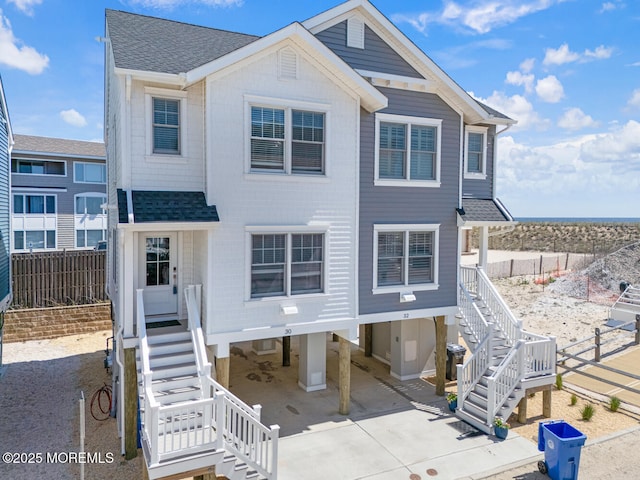 30 Elder St, Mantoloking, NJ 08738 - view of front of property featuring stairway, a carport, a shingled roof, and driveway