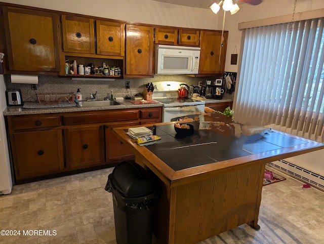 kitchen with tasteful backsplash, brown cabinets, white appliances, and a sink