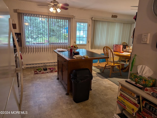 interior space with a ceiling fan and a baseboard radiator