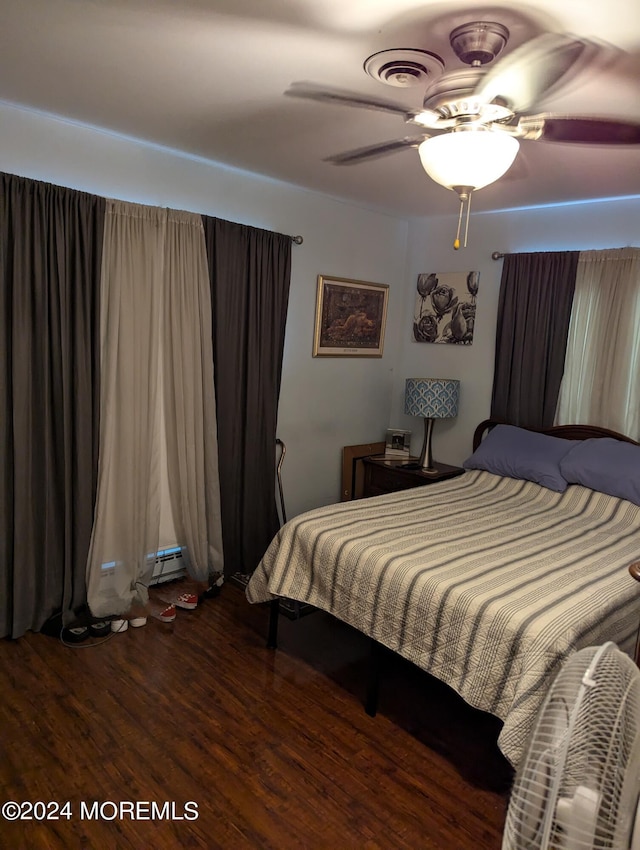 bedroom featuring visible vents, wood finished floors, and a ceiling fan