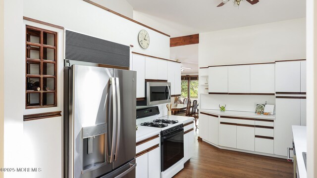 kitchen with appliances with stainless steel finishes, light countertops, white cabinetry, and ceiling fan