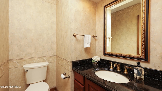 bathroom with toilet and vanity