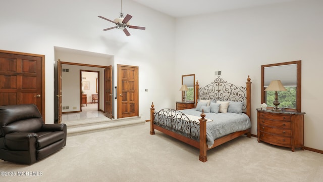 bedroom featuring high vaulted ceiling, light colored carpet, baseboards, and ceiling fan