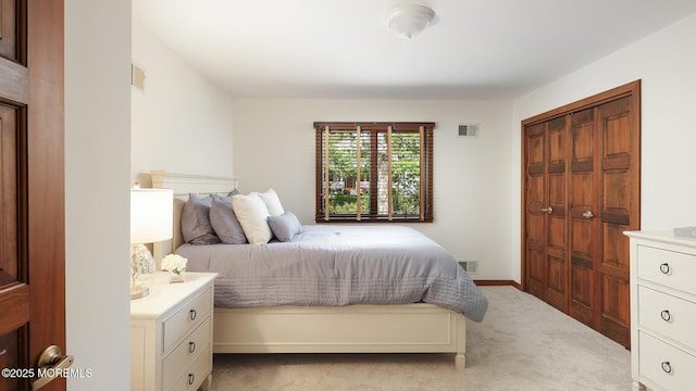 bedroom with light carpet and a closet