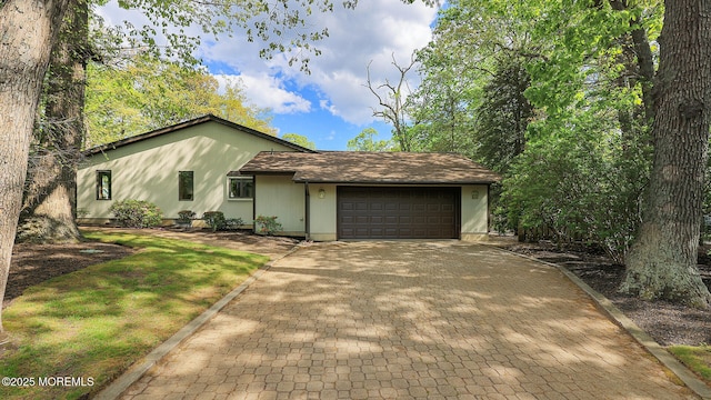 view of front of home featuring decorative driveway and an attached garage