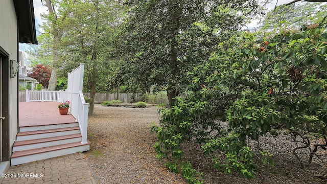 view of yard with fence and a deck
