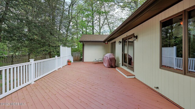 wooden terrace featuring fence