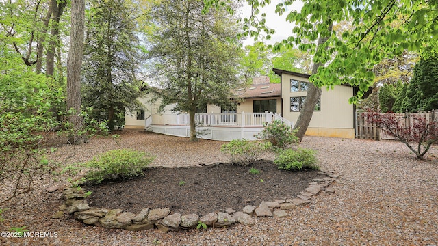 view of front facade featuring a deck and fence