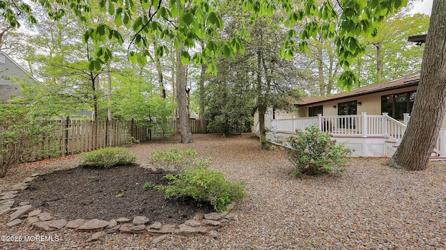 view of yard with fence and a deck