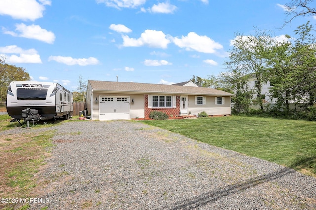 ranch-style home featuring a garage, driveway, and a front yard