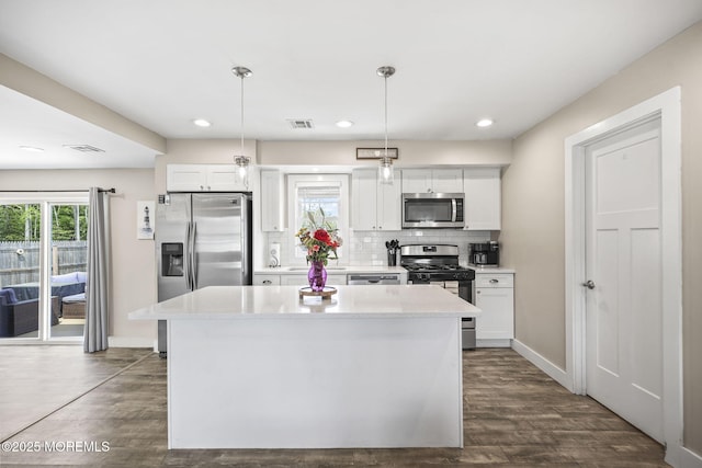 kitchen with stainless steel appliances, dark wood-style flooring, white cabinets, and recessed lighting