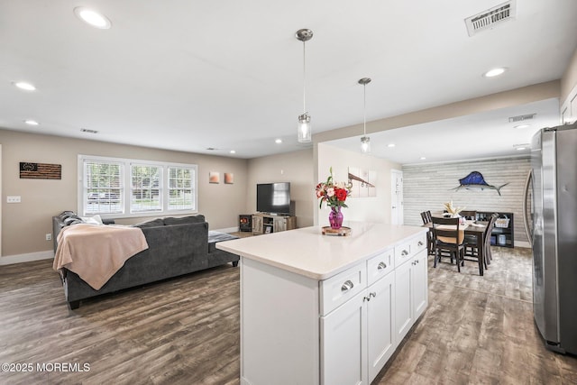 kitchen with freestanding refrigerator, open floor plan, wood finished floors, white cabinetry, and recessed lighting