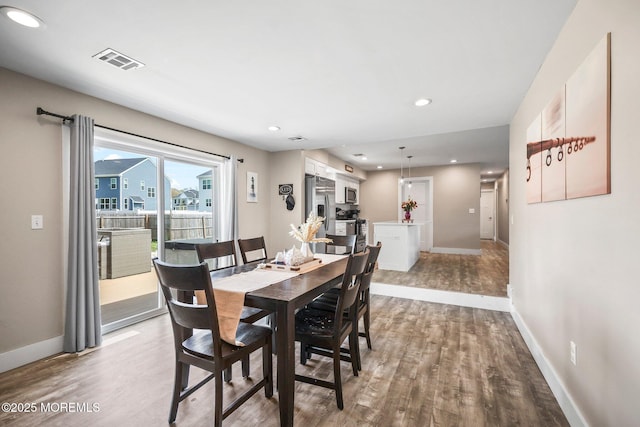 dining area featuring wood finished floors, baseboards, and recessed lighting