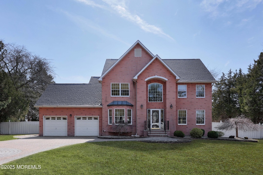 145 Dugan Ln, Toms River, NJ 08753 - view of front of home featuring brick siding, a garage, driveway, and roof with shingles