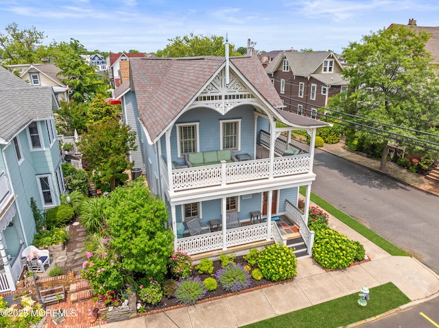 91 Cookman Ave, Ocean Grove, NJ 07756 - victorian-style house featuring a balcony, a porch, roof with shingles, and a residential view