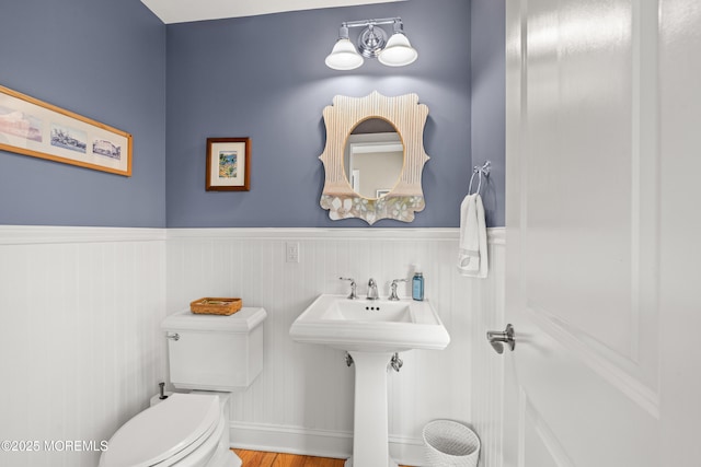 91 Cookman Ave, Ocean Grove, NJ 07756 - half bathroom with a wainscoted wall, toilet, and wood finished floors