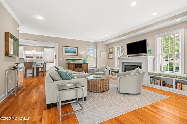 91 Cookman Ave, Ocean Grove, NJ 07756 - living area featuring ornamental molding, a warm lit fireplace, wood finished floors, and recessed lighting