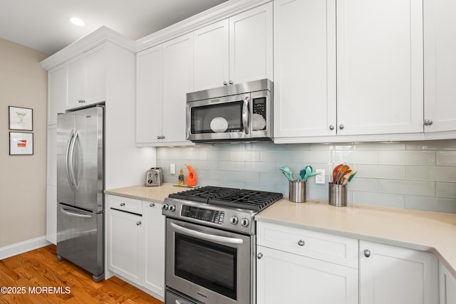 91 Cookman Ave, Ocean Grove, NJ 07756 - kitchen featuring stainless steel appliances, baseboards, backsplash, white cabinets, and recessed lighting
