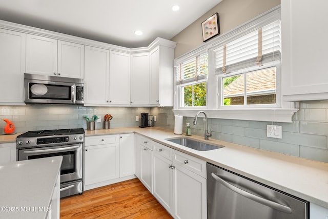 91 Cookman Ave, Ocean Grove, NJ 07756 - kitchen featuring stainless steel appliances, a sink, light countertops, tasteful backsplash, and recessed lighting